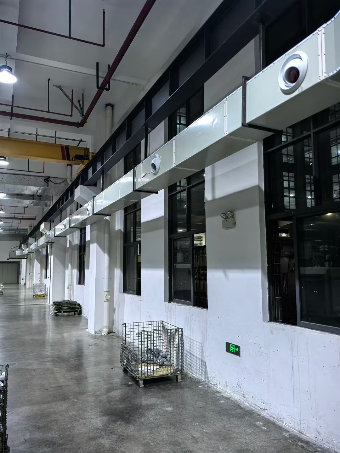 Energy saving air conditioner duct installation along an industrial workshop corridor