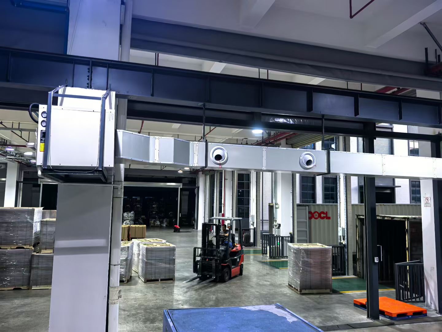 Ducted energy saving air conditioner system for a warehouse work zone